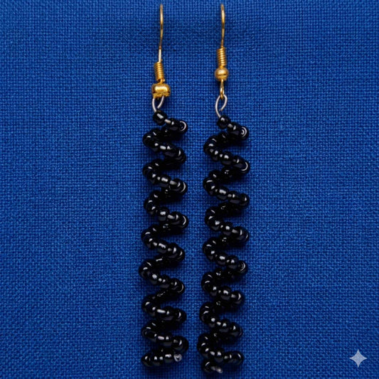 Black beaded earrings on a blue background