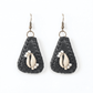 Pair of black teardrop shaped earrings with cowrie shells on a white background