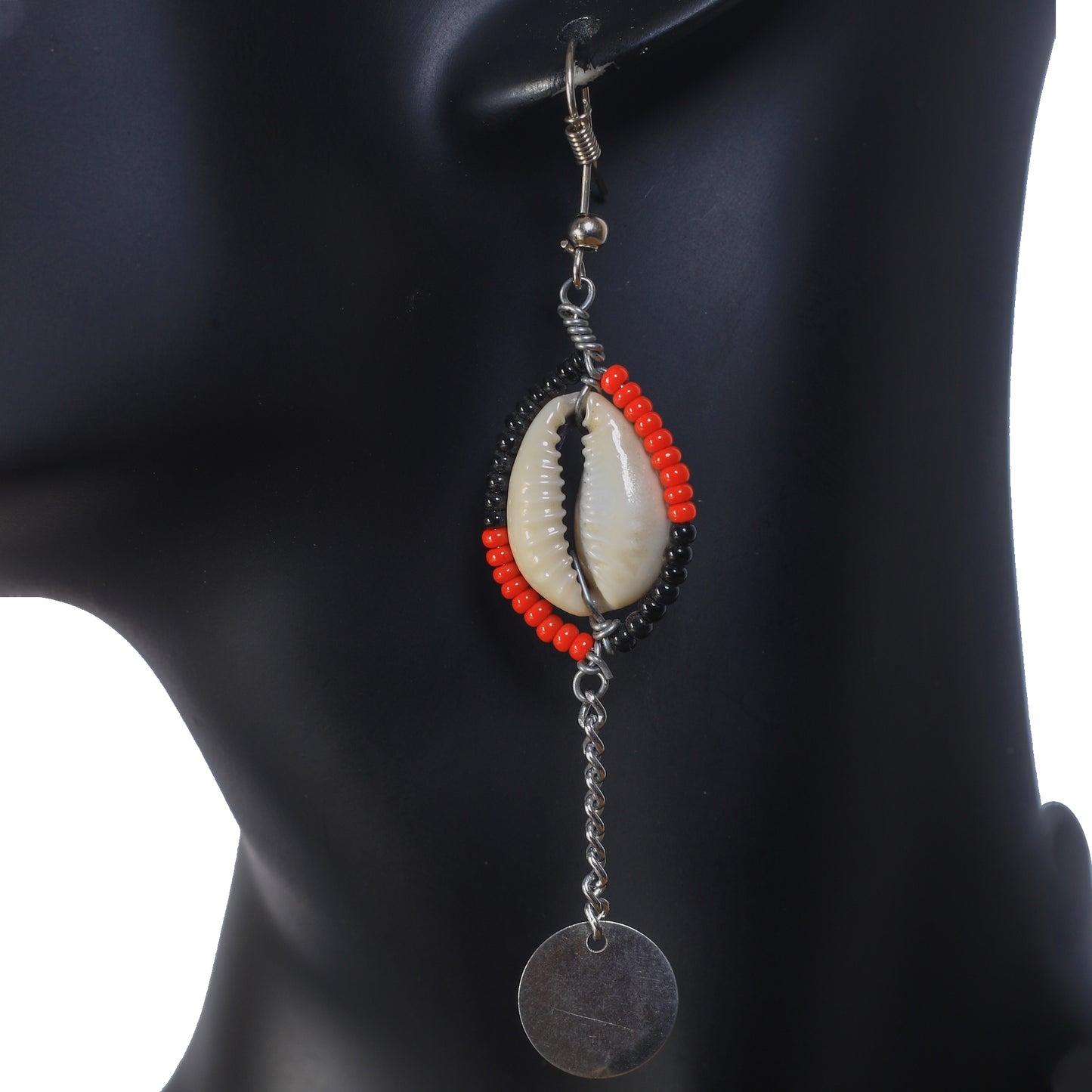 Long dangle earrings with a red and black beaded cowrie shell, a silver-plated chain, and a round disc drop.