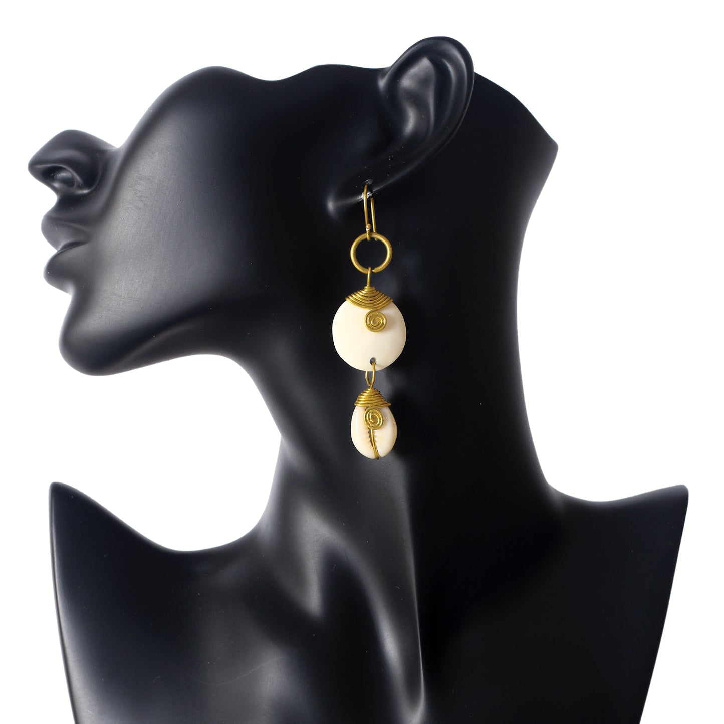 Handmade dangle earrings with a round, wire-wrapped camel bone disc stacked above a wire-wrapped natural cowrie shell.