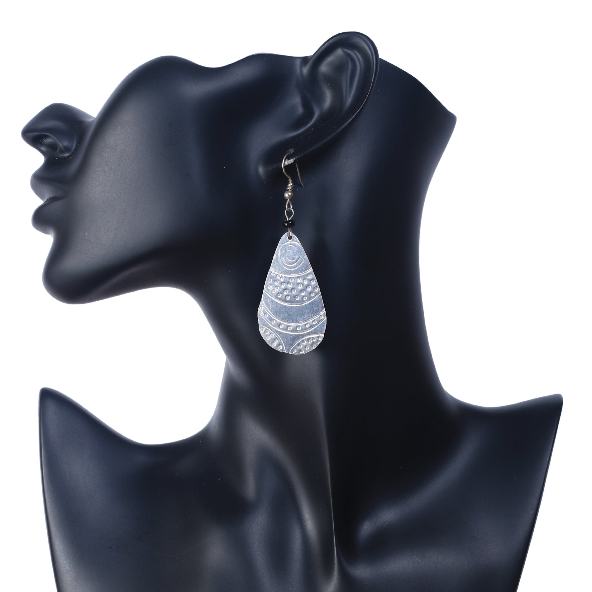 A pair of long, lightweight, silver-plated teardrop earrings with an intricate etched pattern.