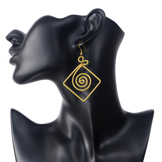 A pair of large, gold-plated geometric earrings with a square wire frame and a round spiral in the center.