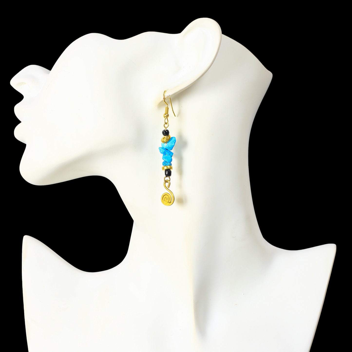 Long gold dangle earrings with turquoise-colored stone chips, black beads, and a gold-plated spiral charm.