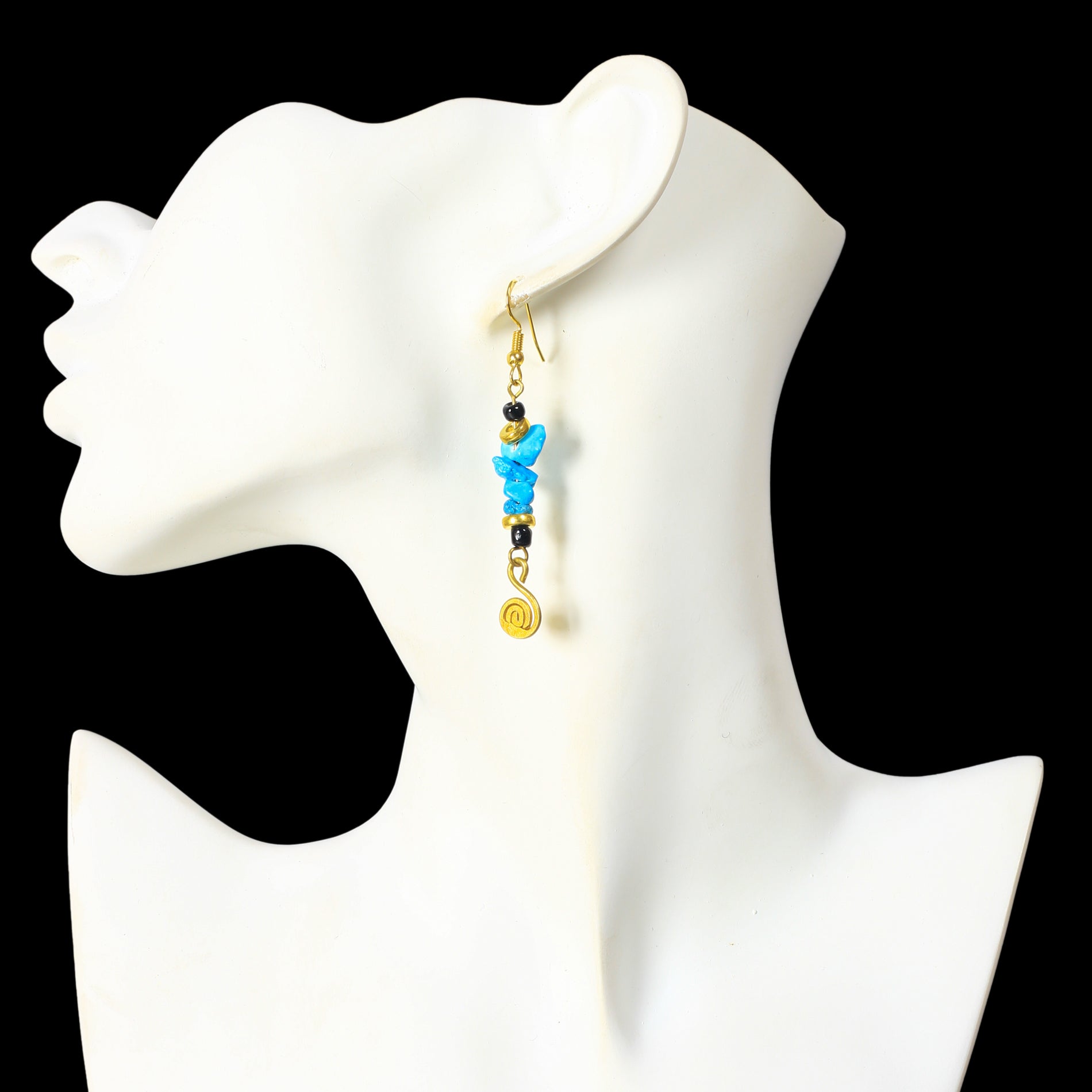 Long gold dangle earrings with turquoise-colored stone chips, black beads, and a gold-plated spiral charm.