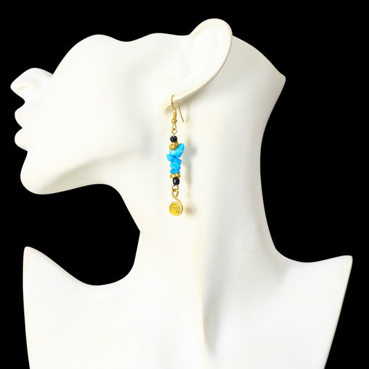 Long gold dangle earrings with turquoise-colored stone chips, black beads, and a gold-plated spiral charm.