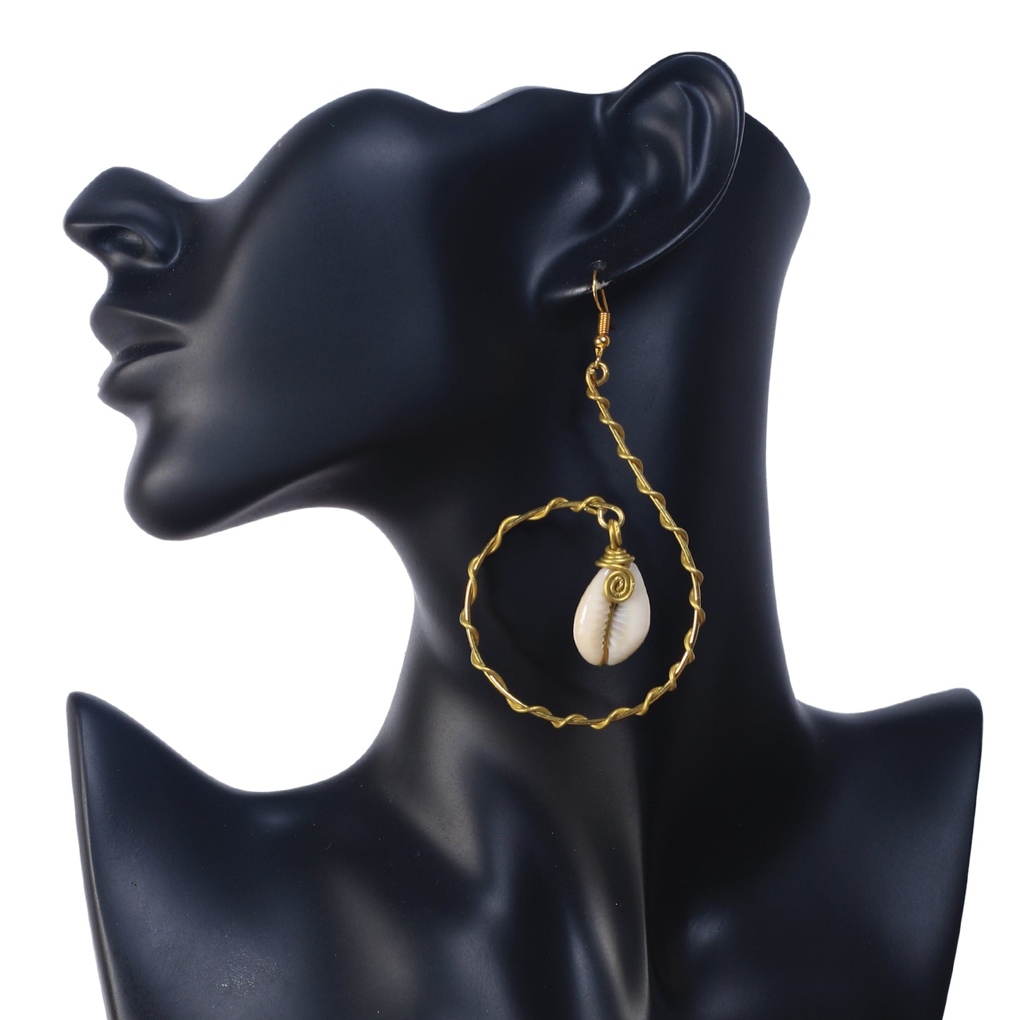 A pair of large, gold-plated spiral hoop earrings with a wavy texture, holding a wire-wrapped natural cowrie shell in the center.
