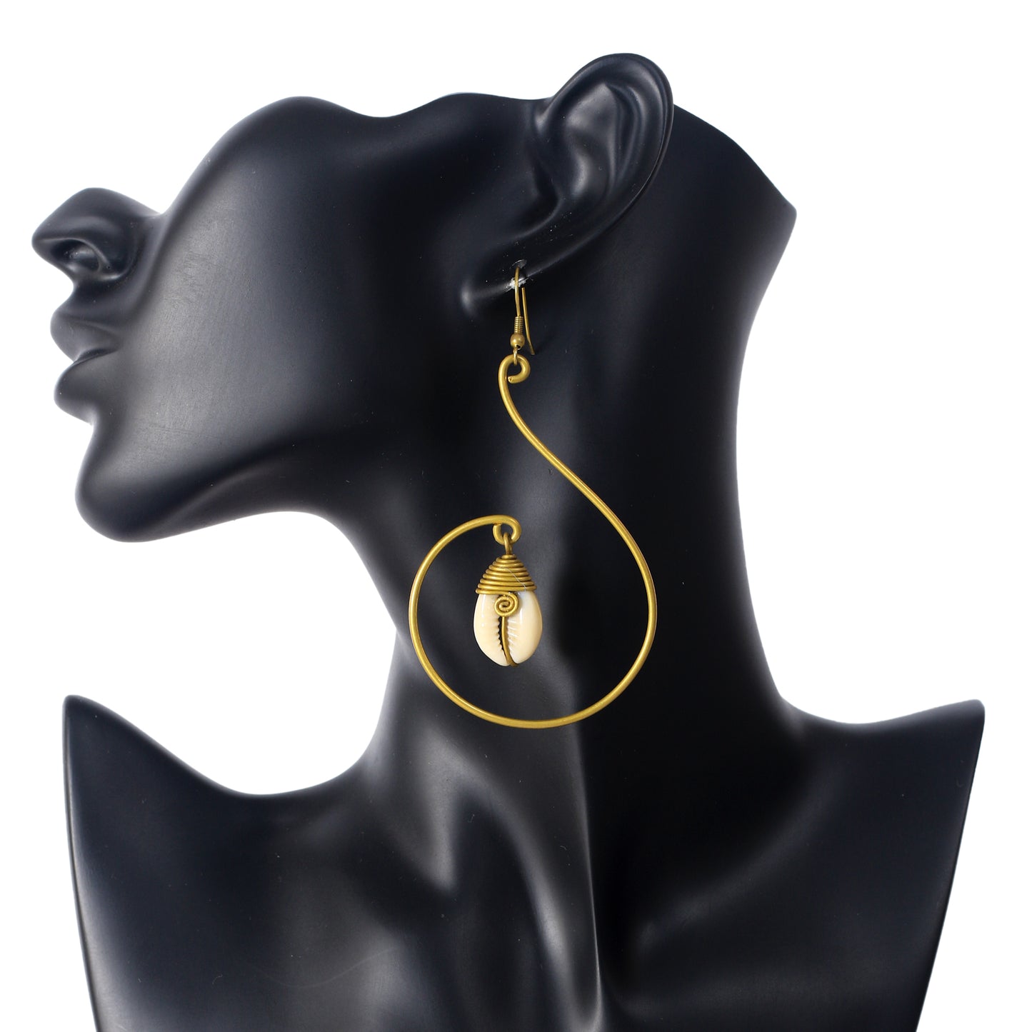 A pair of large, gold-plated spiral earrings with a wire-wrapped natural cowrie shell suspended in the center.