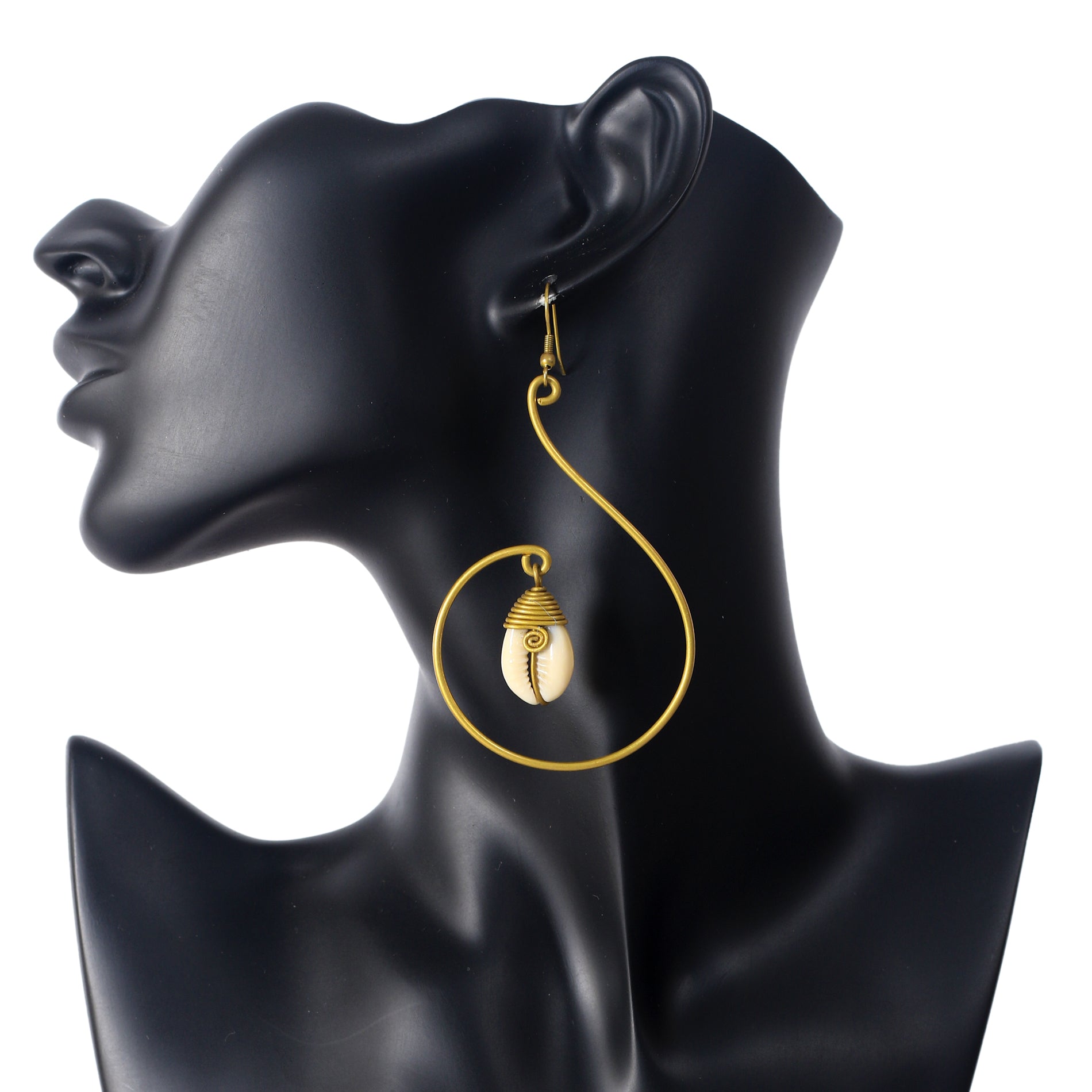 A pair of large, gold-plated spiral earrings with a wire-wrapped natural cowrie shell suspended in the center.