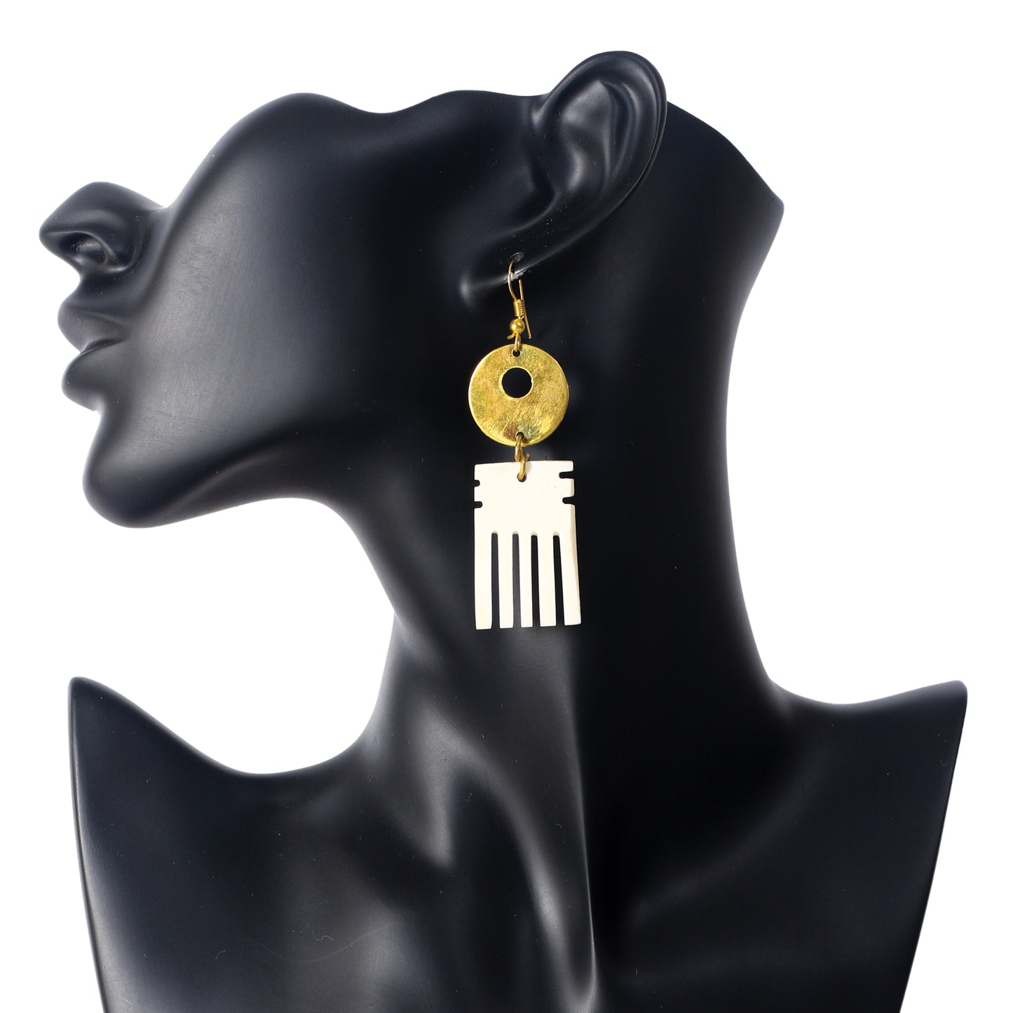 Handmade dangle earrings with a hammered gold-plated disc stacked above a carved, camel bone Afro pick pendant.