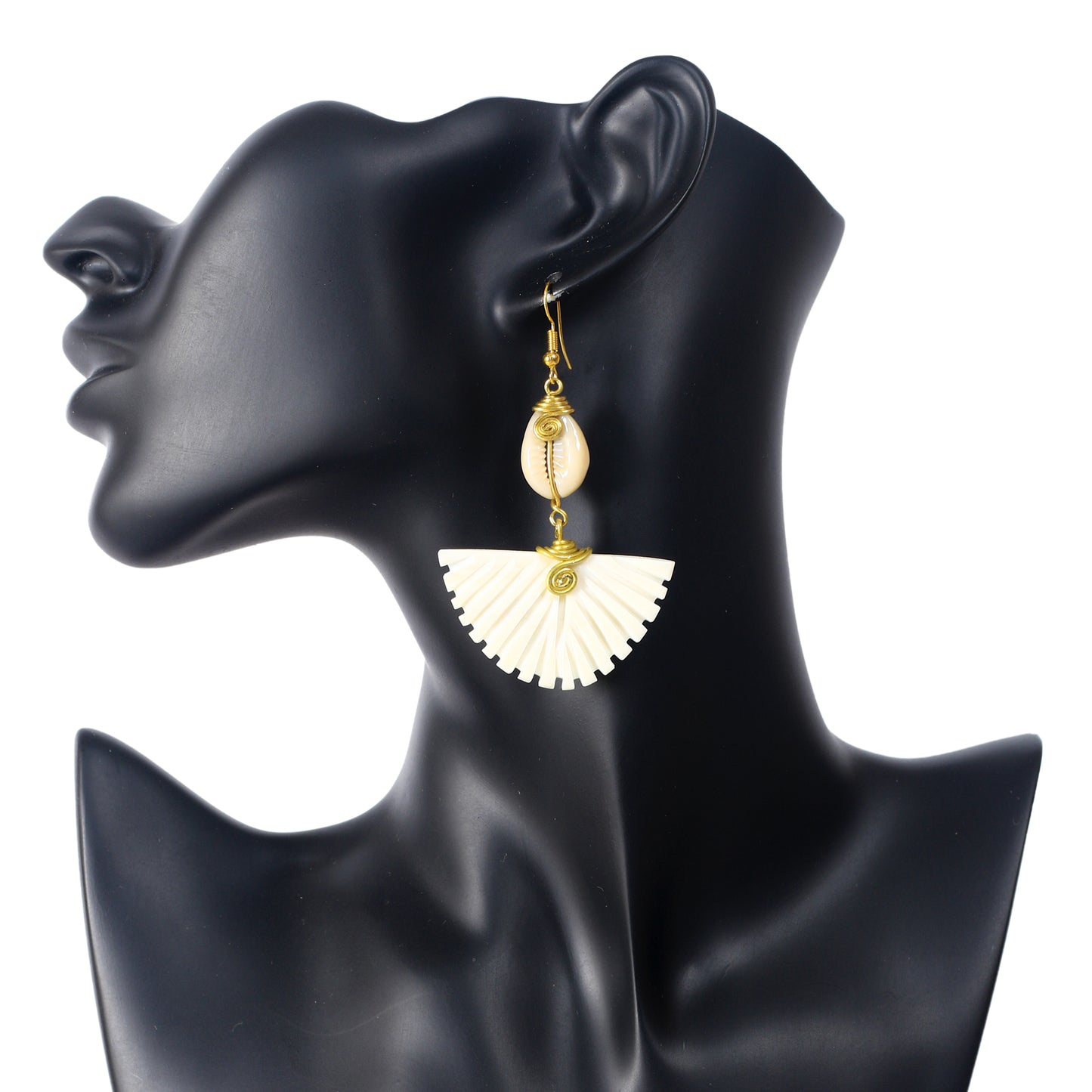 Handmade dangle earrings featuring a wire-wrapped cowrie shell stacked above a large, carved camel bone fan drop.