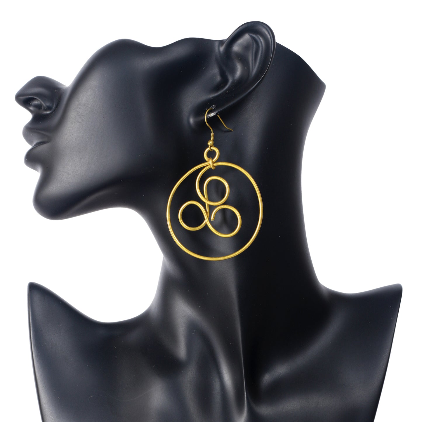 A pair of large, gold-plated hoop earrings with an artistic, triple loop wire symbol in the center.