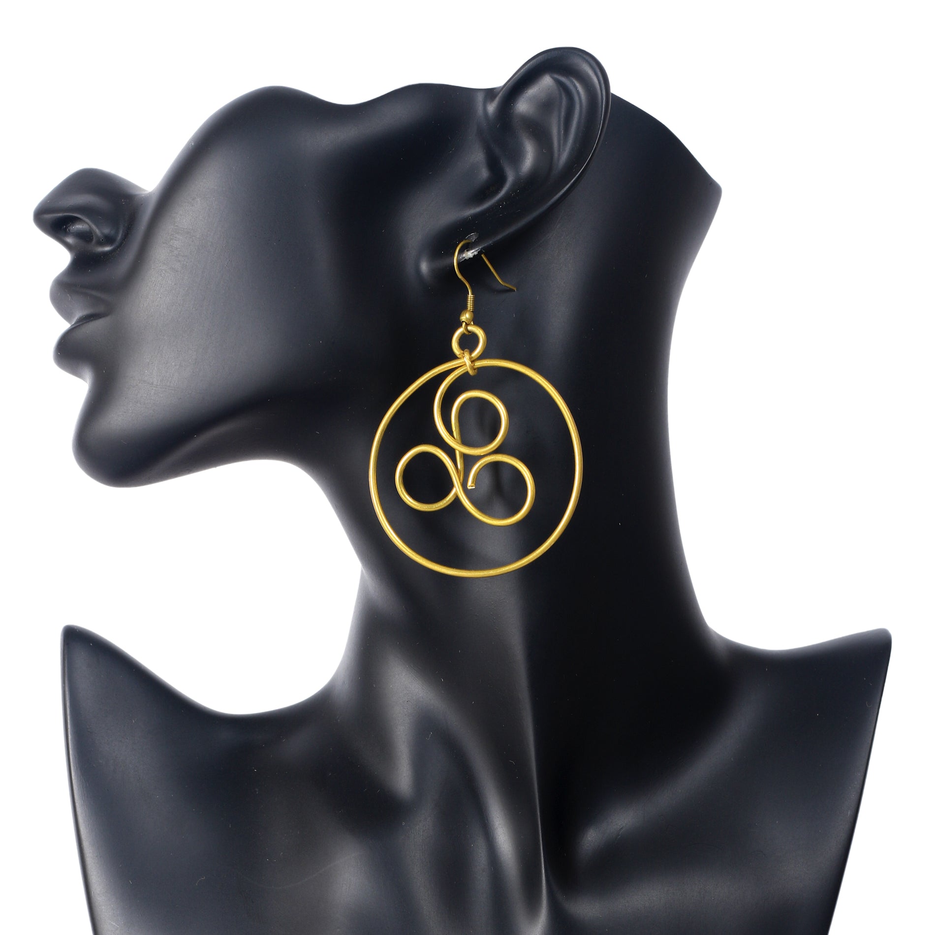A pair of large, gold-plated hoop earrings with an artistic, triple loop wire symbol in the center.