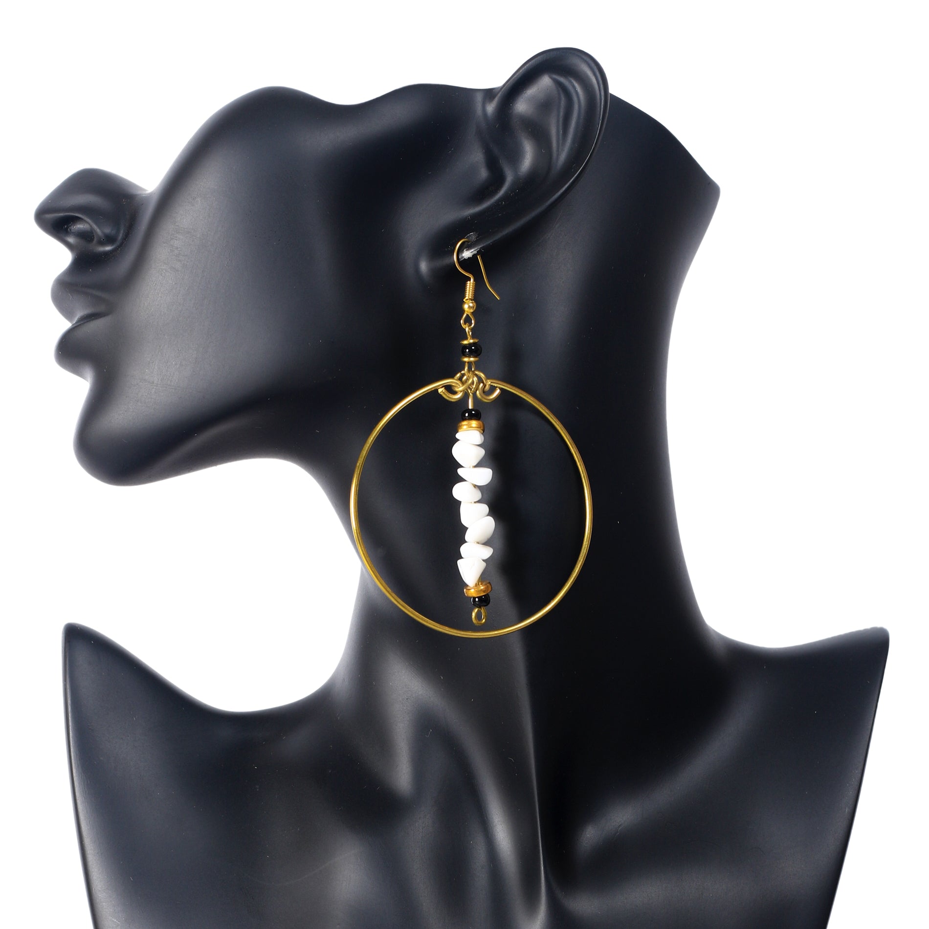 A pair of large, gold-plated hoop earrings with a central bar of white stone chips and black bead accents.