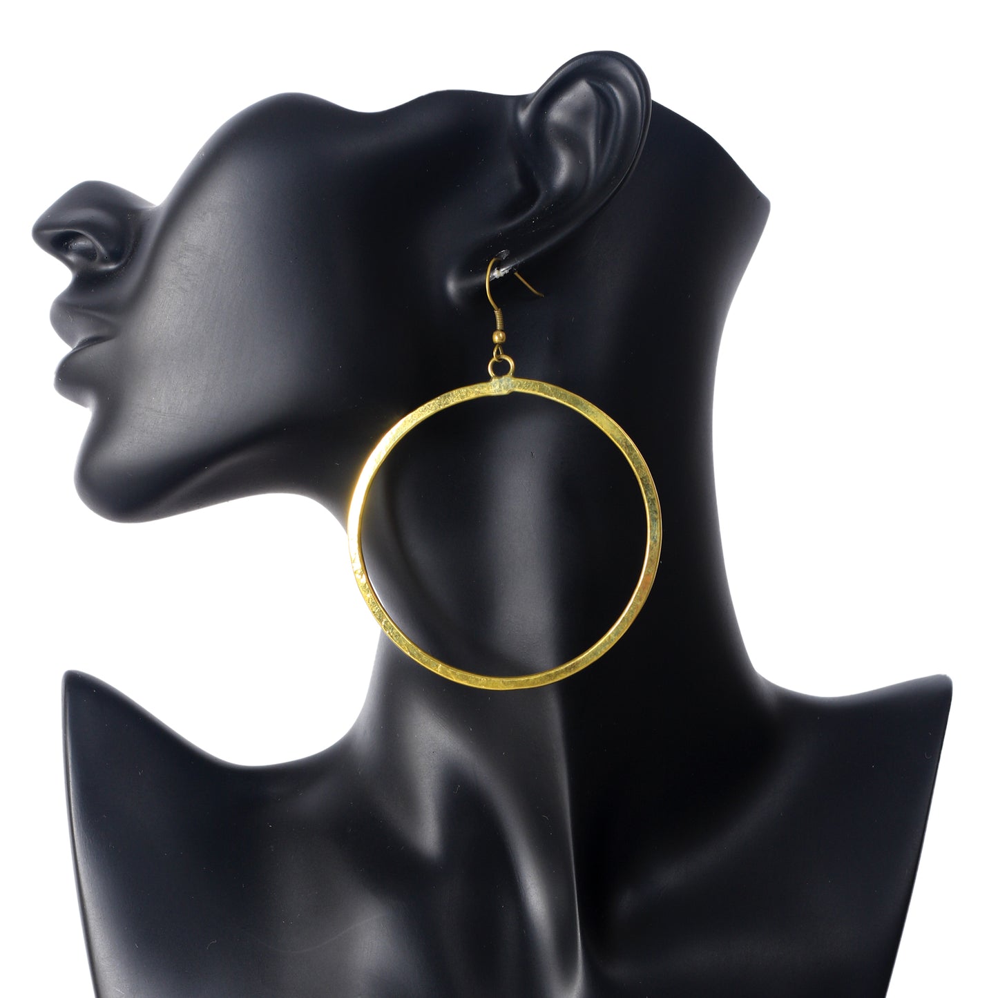 A pair of large, oversized, gold plated hoop earrings with a flat profile and a brushed matte finish.