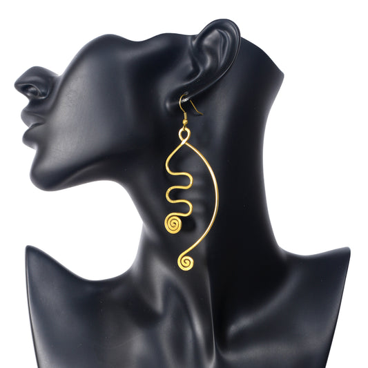 A pair of large, gold-plated wire earrings in a free-form, sculptural design with abstract spirals and curves.