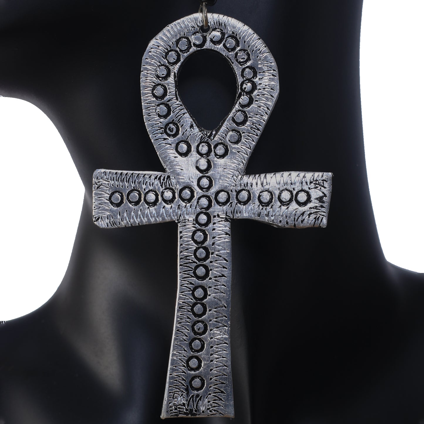 A pair of large, silver-plated Ankh symbol earrings with a stamped, textural dot pattern.
