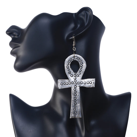 A pair of large, silver-plated Ankh symbol earrings with a stamped, textural dot pattern.