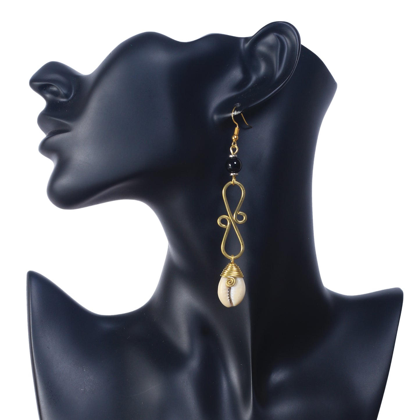 Long gold dangle earrings featuring a black bead, a wire scrollwork design, and a wire-wrapped cowrie shell at the bottom.