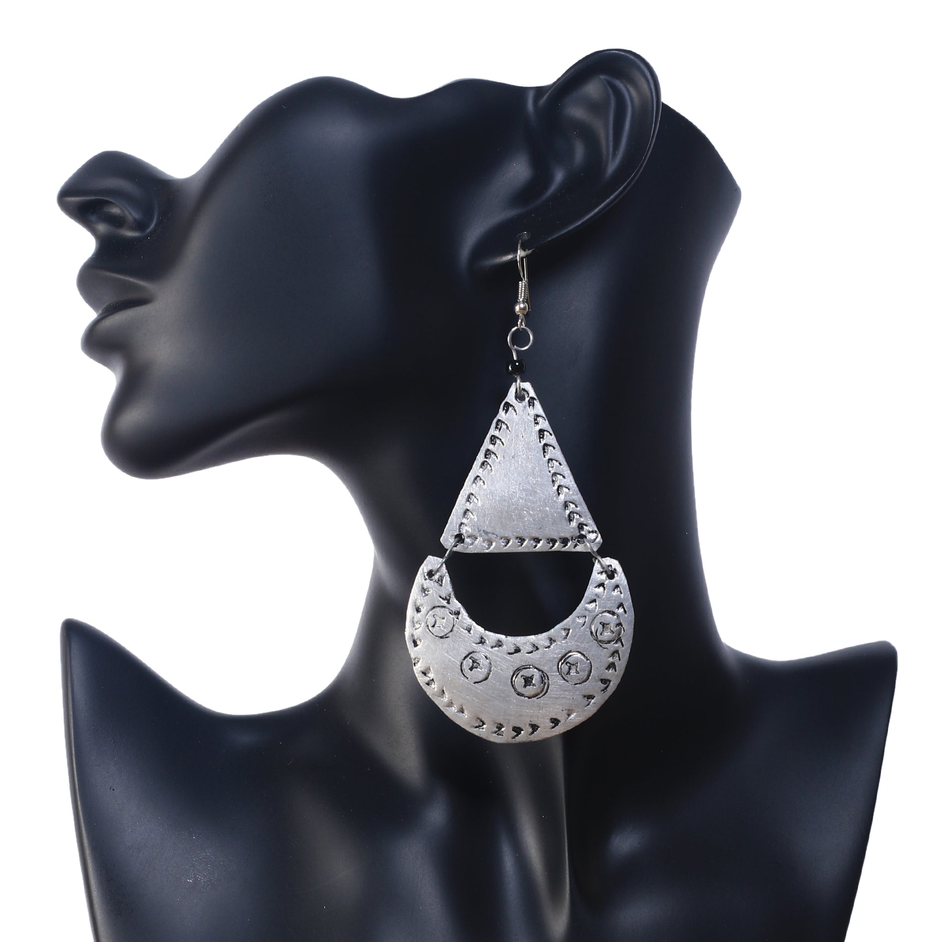A pair of large, silver-plated geometric earrings featuring an etched triangle and a stamped crescent drop.