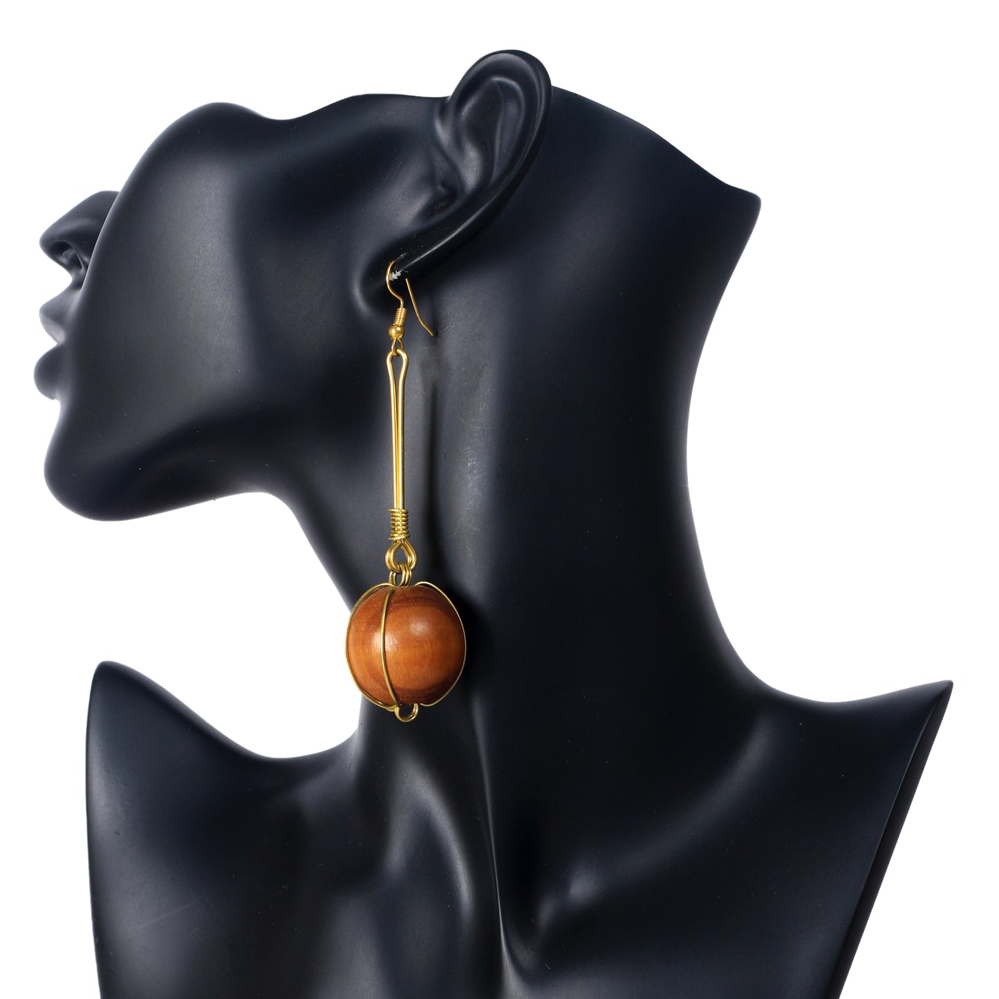 A pair of long, gold-plated bar dangle earrings with a large wooden sphere in a gold wire cage at the bottom.