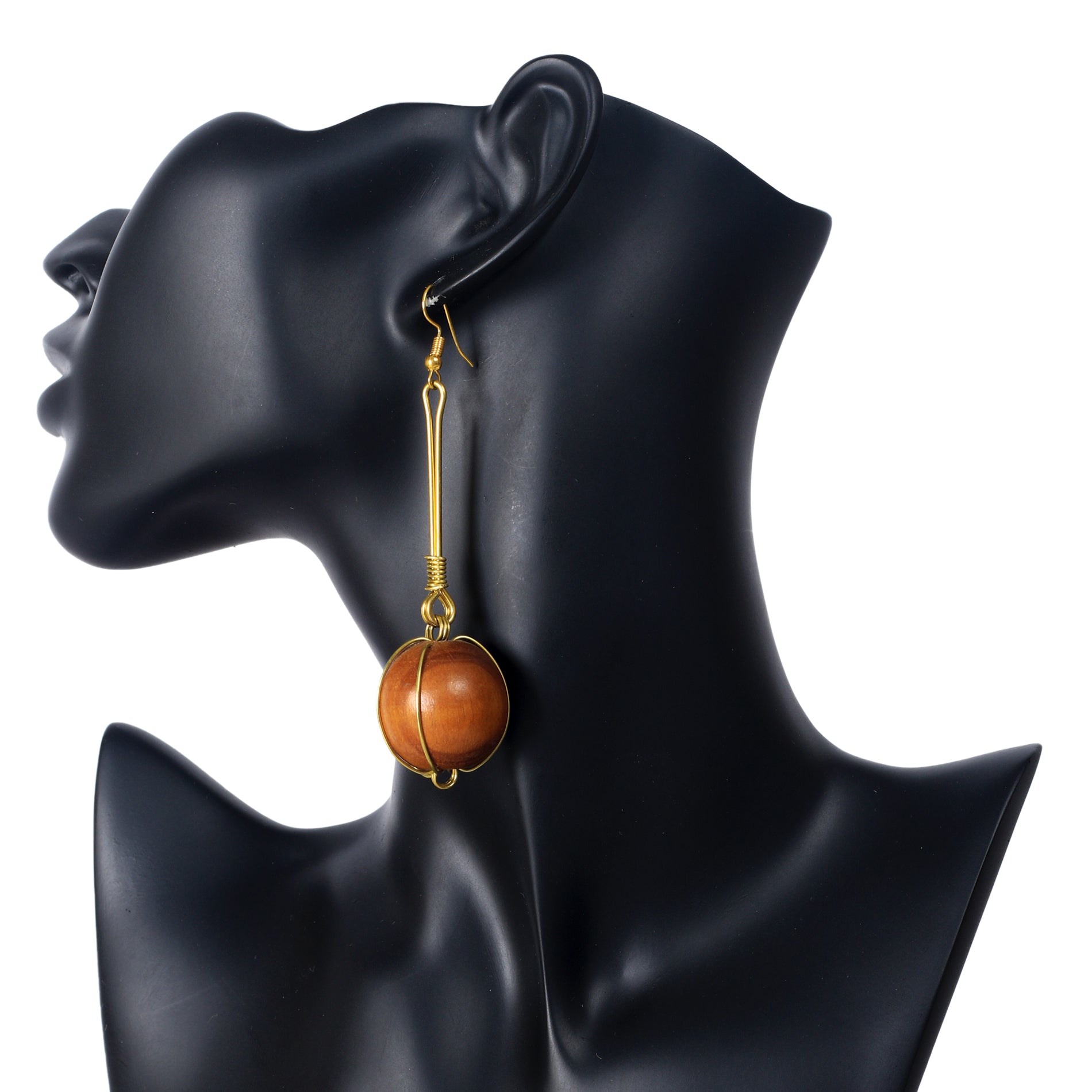 A pair of long, gold-plated bar dangle earrings with a large wooden sphere in a gold wire cage at the bottom.