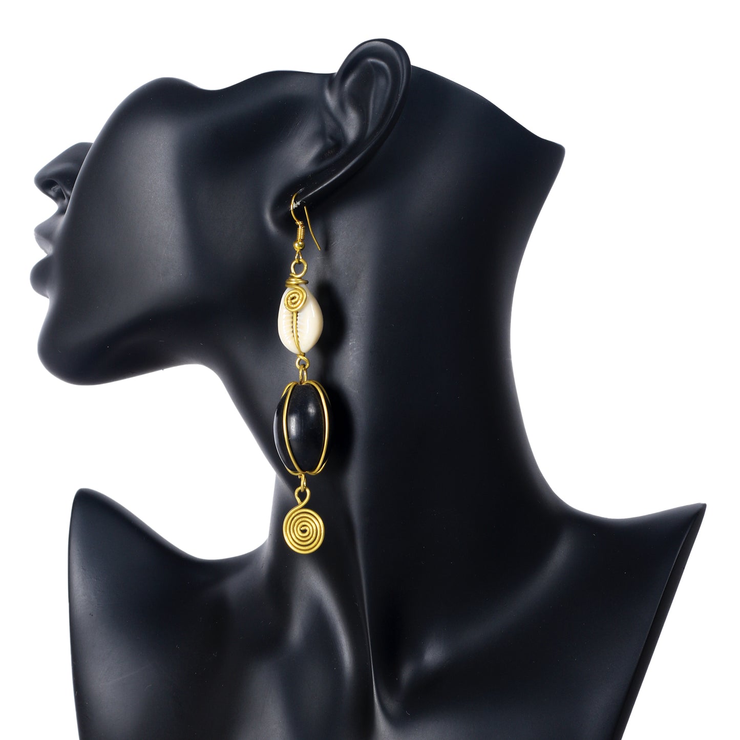 Long gold-plated dangle earrings with a wire-wrapped cowrie shell, a large black bead, and a coiled spiral disc.