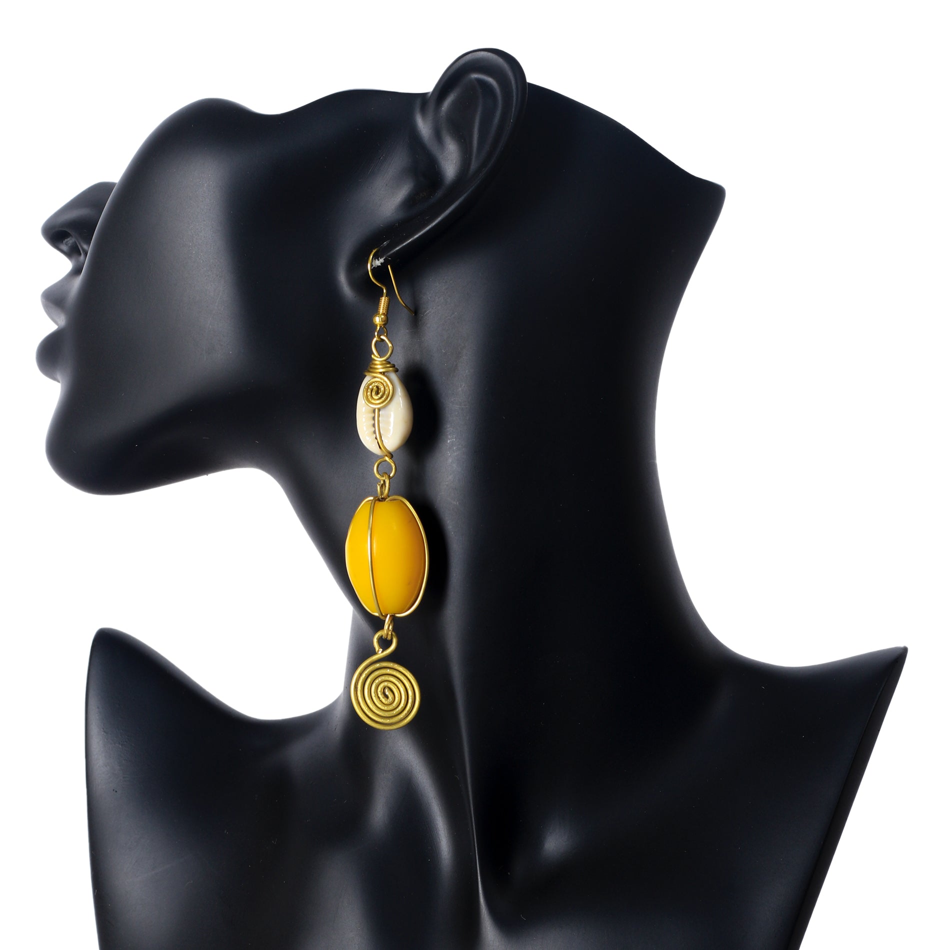 Long gold-plated dangle earrings with a wire-wrapped cowrie shell, a large yellow bead, and a coiled spiral disc.