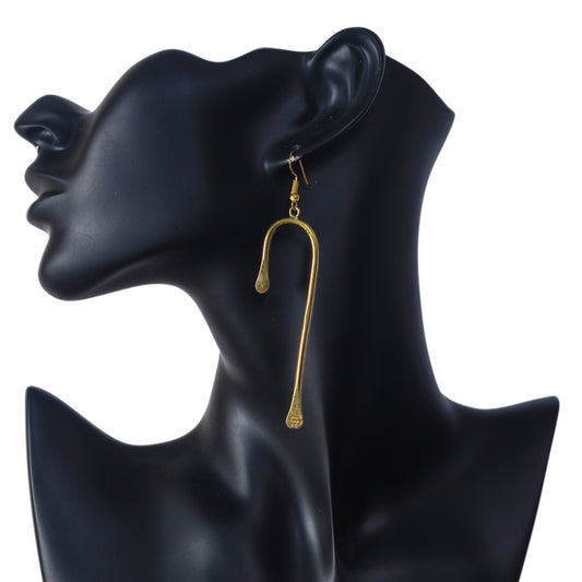A pair of long, modern, gold-plated dangle earrings in a sculptural U-shape with flattened ends.