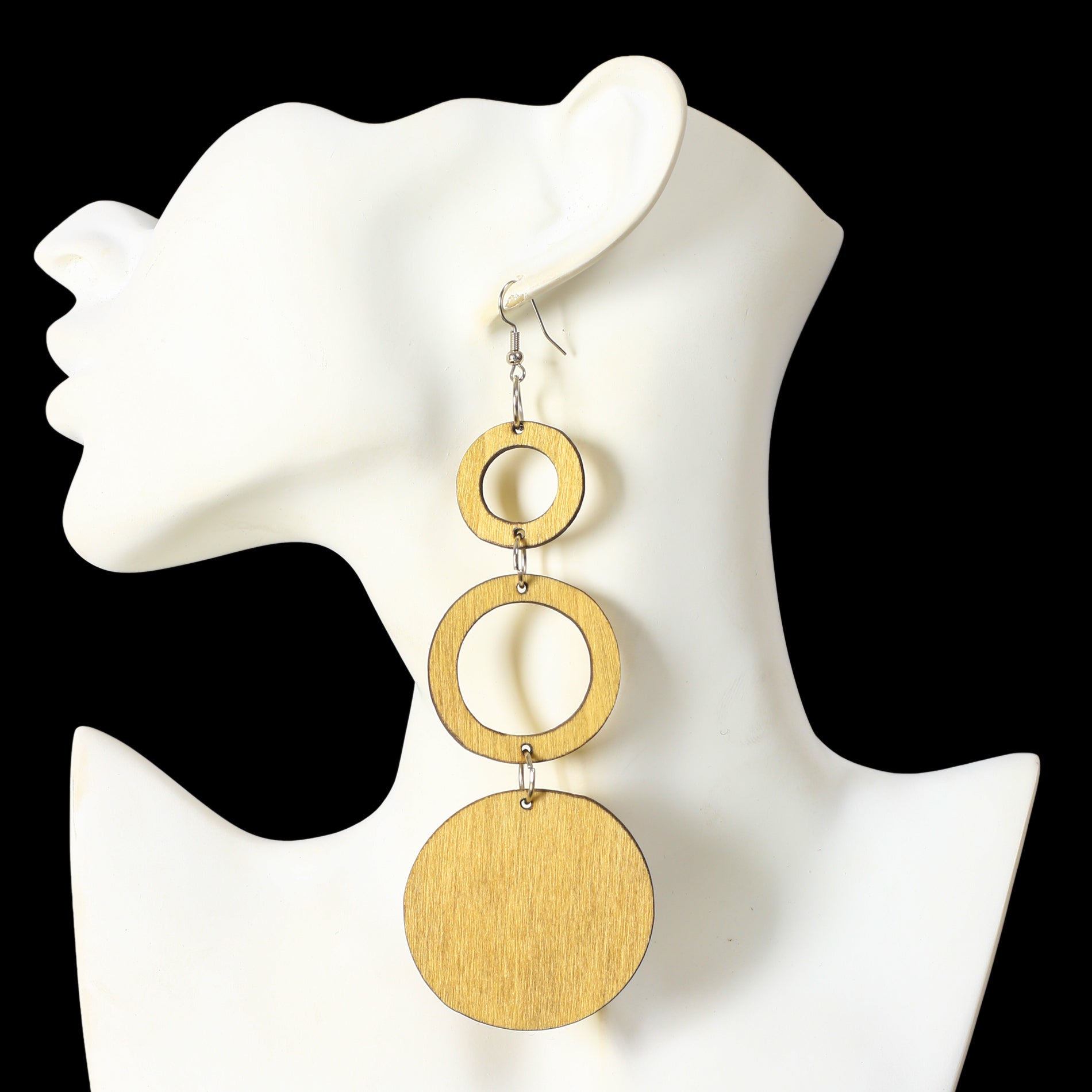 A pair of long, stacked wooden earrings featuring two open rings and a large solid disc at the bottom.