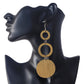A pair of long, stacked wooden earrings featuring two open rings and a large solid disc at the bottom.