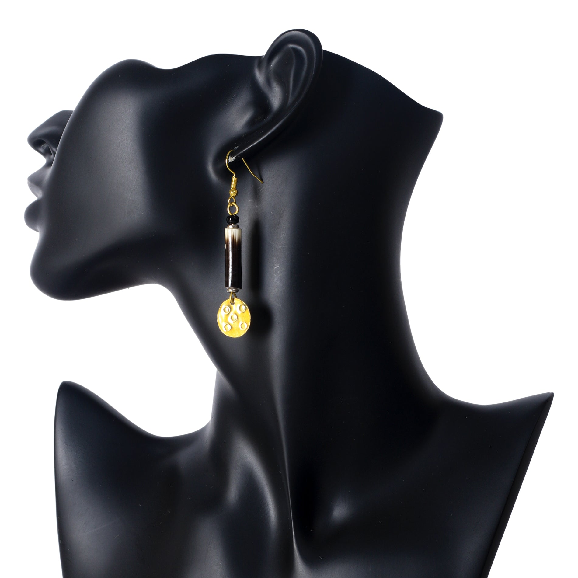 Long gold dangle earrings featuring a porcupine quill and a bright yellow disc with a stamped pattern.