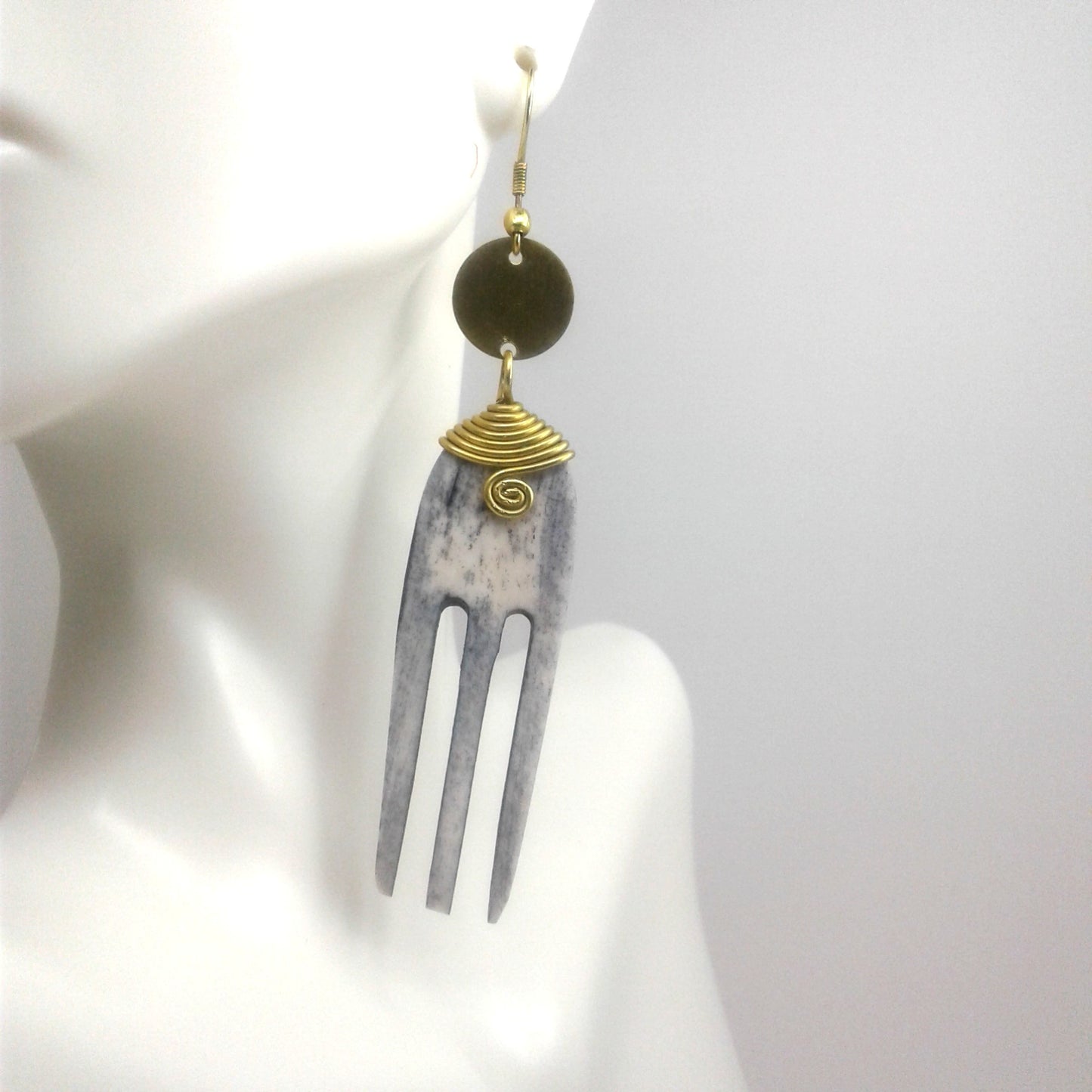 Long Earrings came with camel bone and gold plated brass. The camel bone is carved into an afro pick comb.